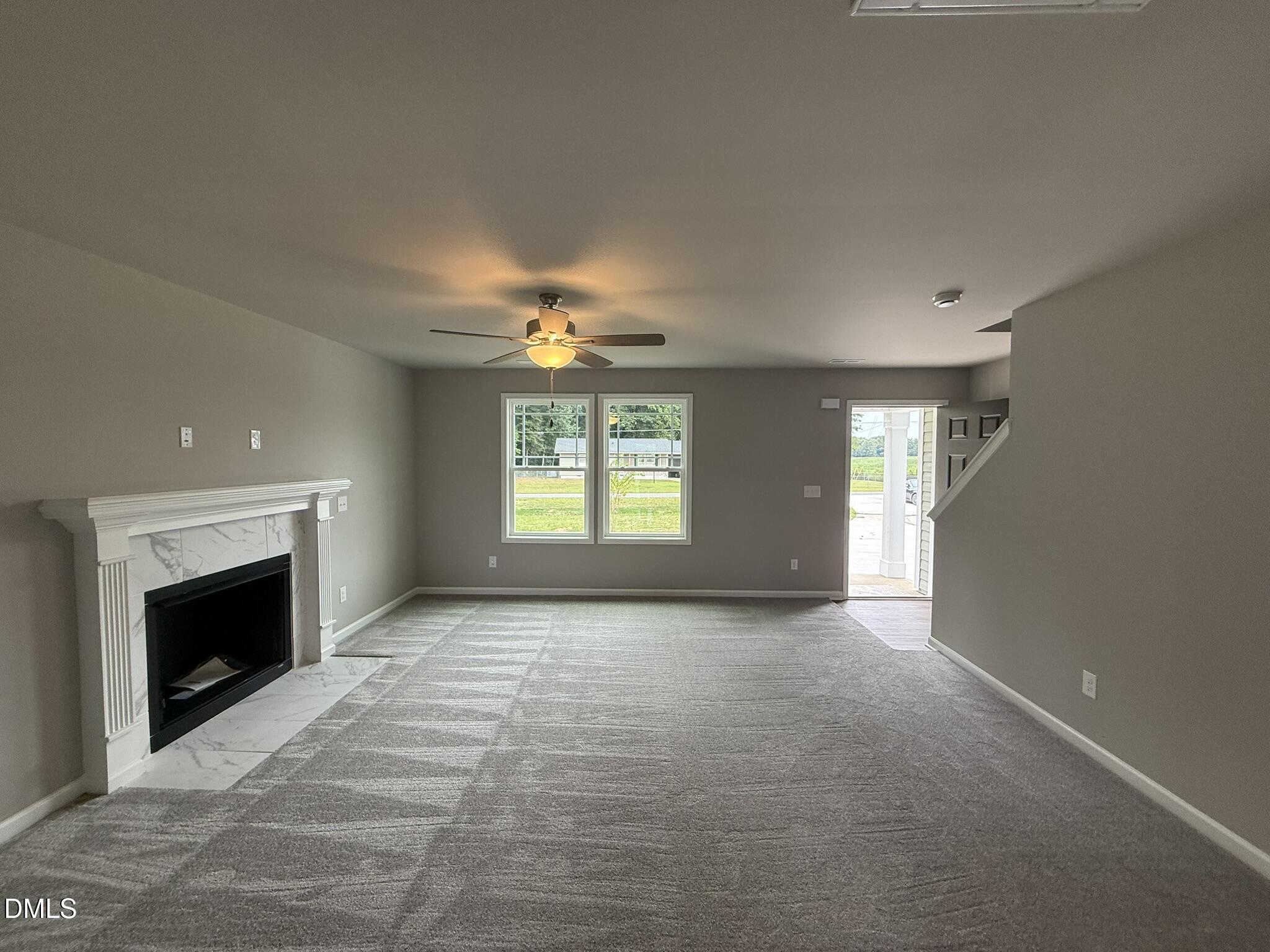 1859 Old Kenly Road Kenly, NC 27542 - Photo 7 of 22 an empty room with windows and fireplace