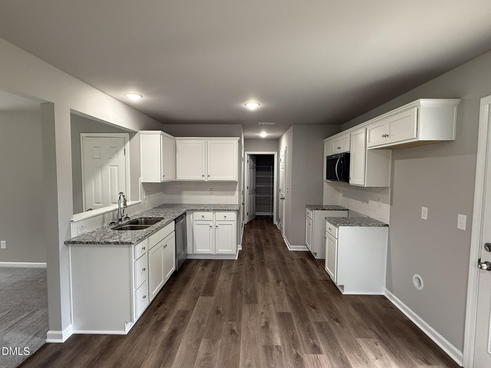 1859 Old Kenly Road Kenly, NC 27542 - Photo 9 of 22 a kitchen with stainless steel appliances granite countertop a stove and cabinets