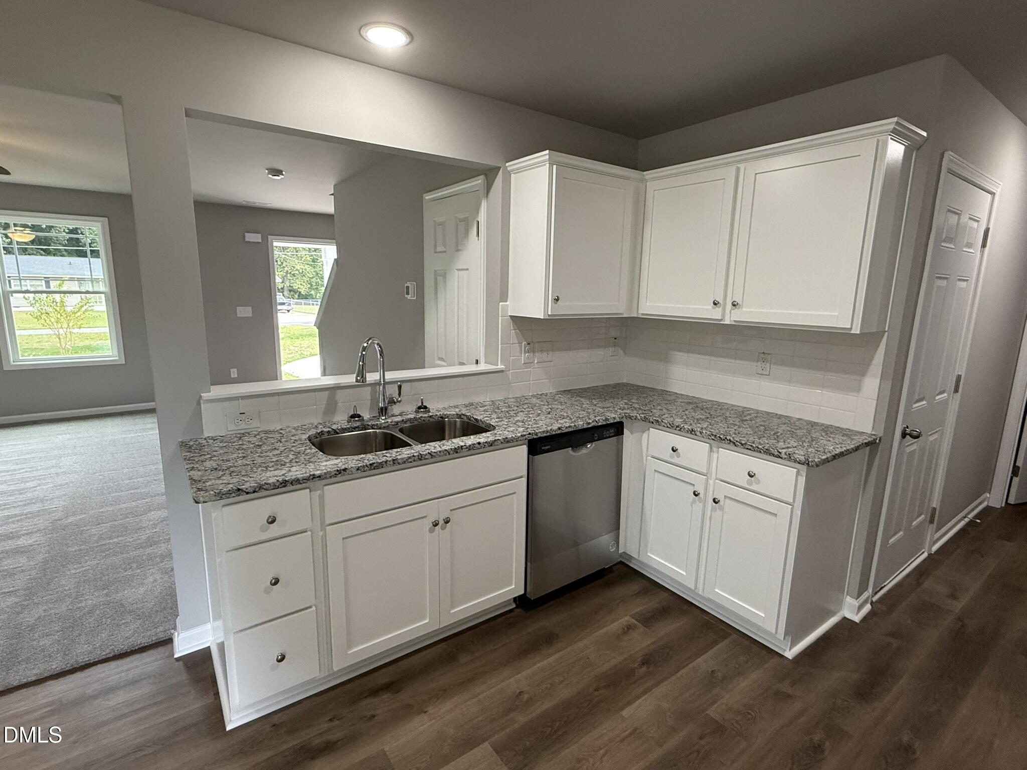 1859 Old Kenly Road Kenly, NC 27542 - Photo 10 of 22 a kitchen with granite countertop white cabinets and white appliances