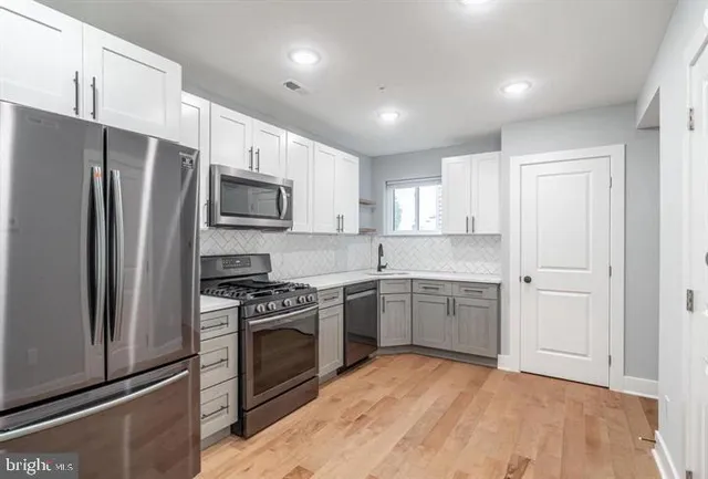 a kitchen with a sink stove and refrigerator