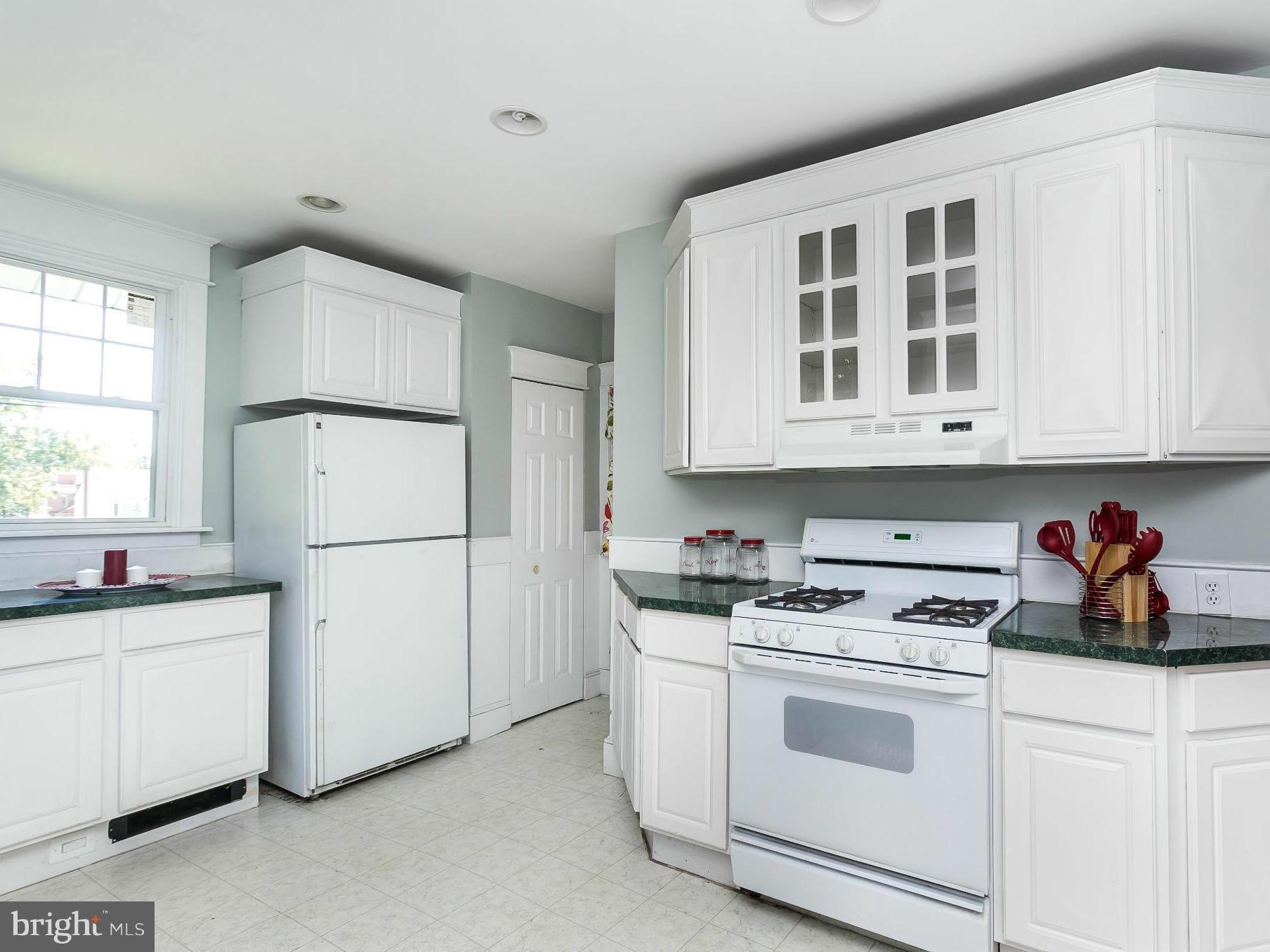 3229 Marnat Road Baltimore, MD 21208 - Photo 14 of 30 a kitchen with white cabinets and white appliances