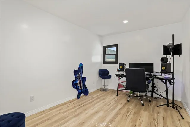 a view of a workspace with furniture and a window