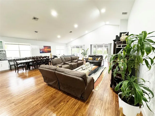 a living room with furniture and a potted plant