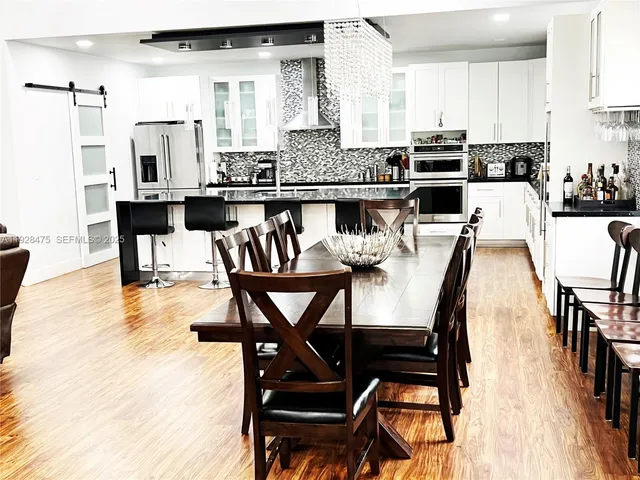 a view of a dining room with furniture and wooden floor