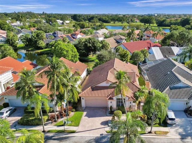 an aerial view of residential houses with outdoor space and street view