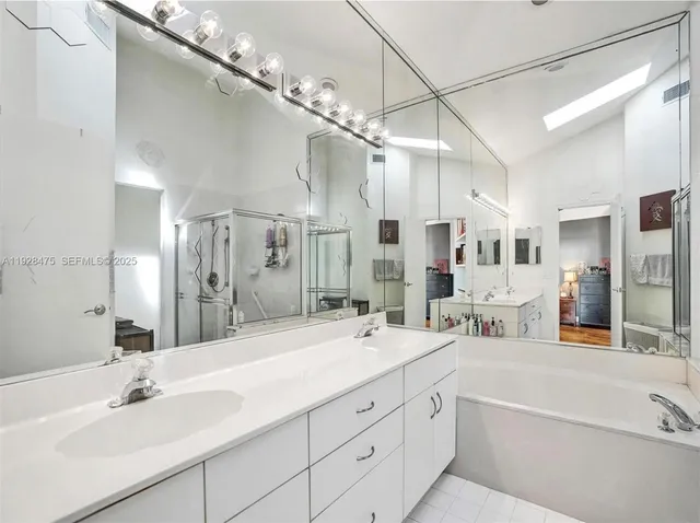a spacious bathroom with a double vanity sink mirror and double