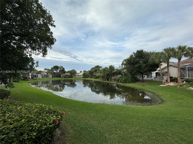 a view of a lake with houses in back