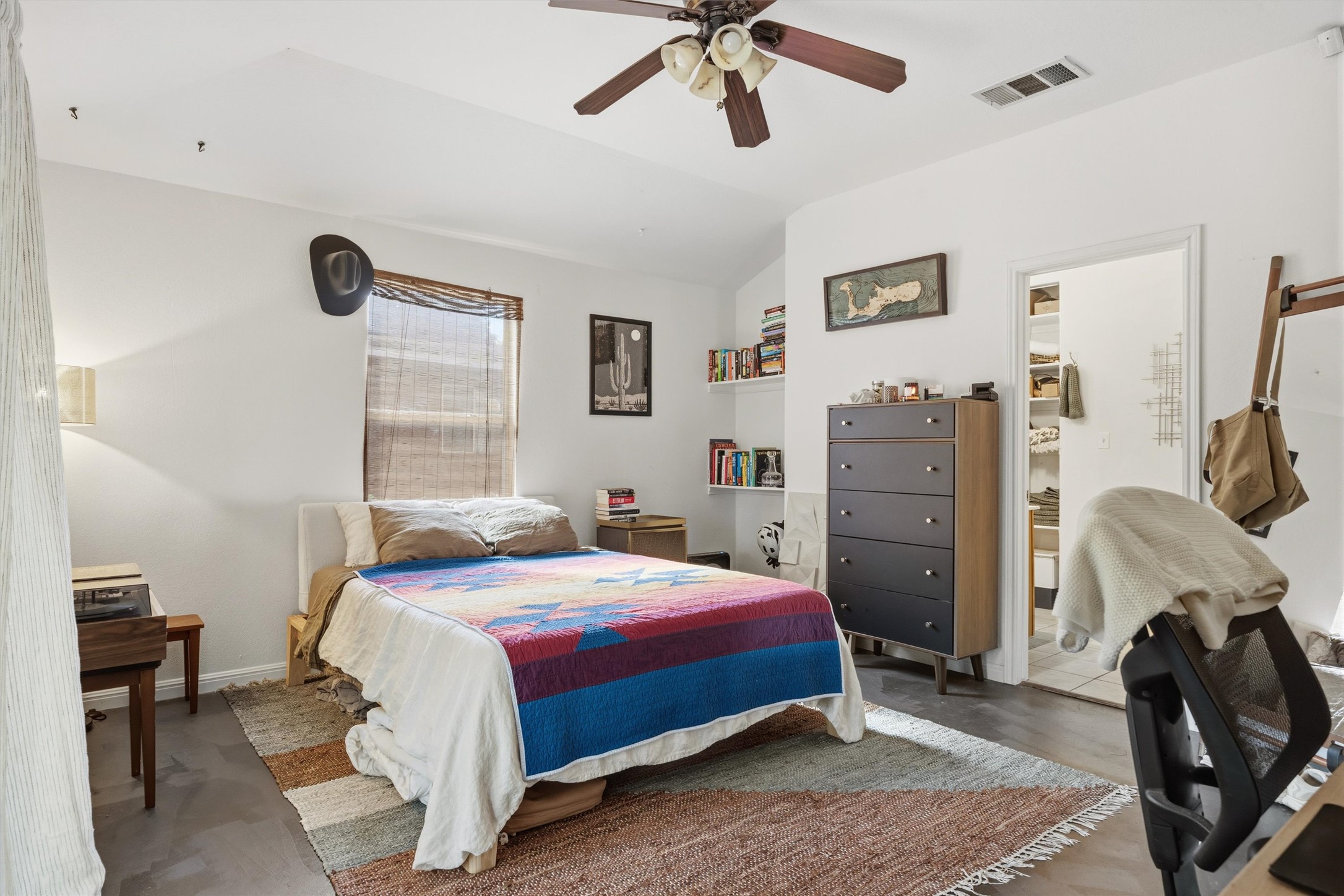 3015 Castro Street Austin, TX 78702 - Photo 22 of 40 Well-lit room with vaulted ceilings, a ceiling fan, and concrete flooring.