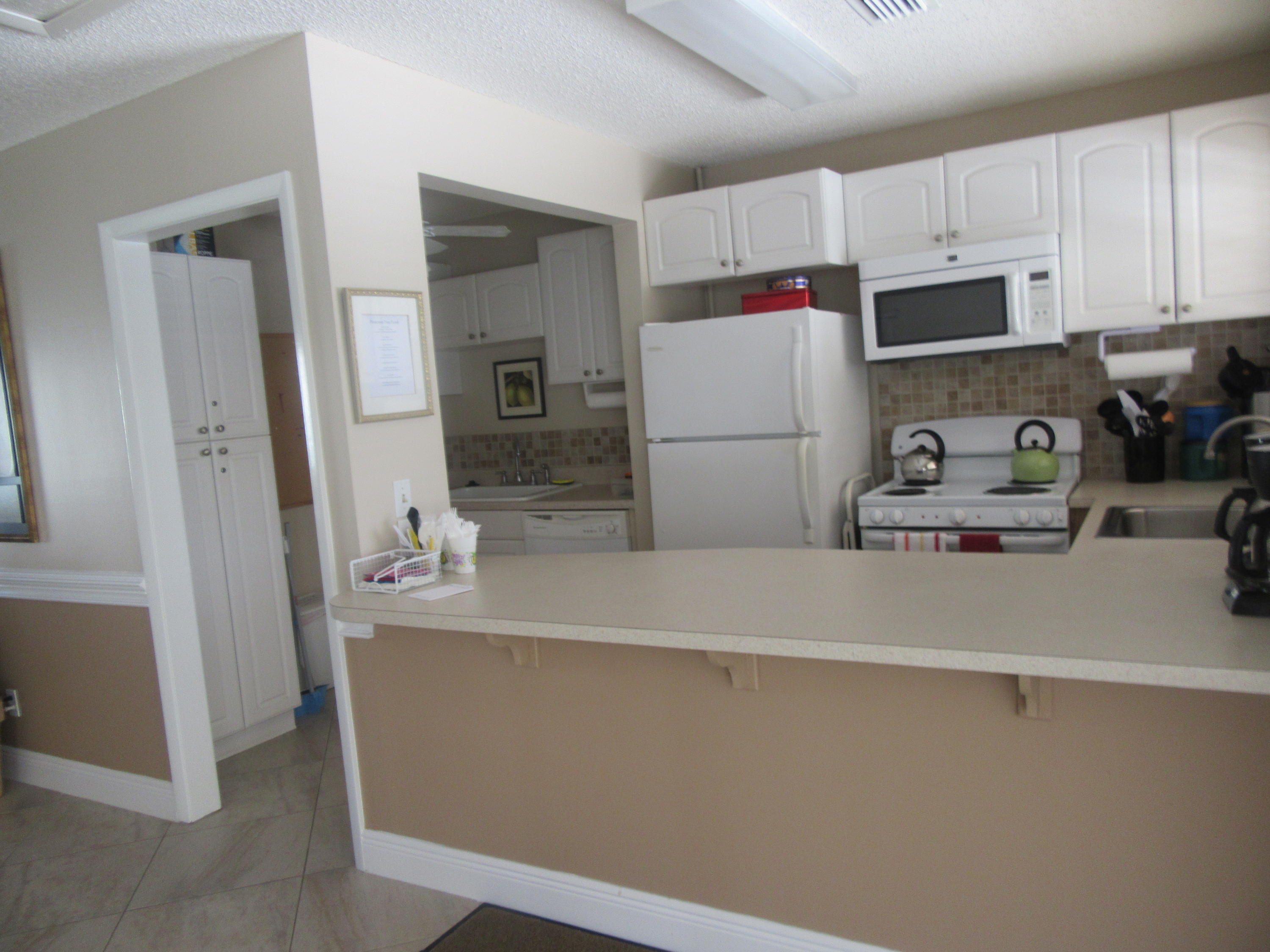 901 Pinecrest Circle, Unit D Jupiter, FL 33458 - Photo 22 of 24 Clubhouse Kitchen