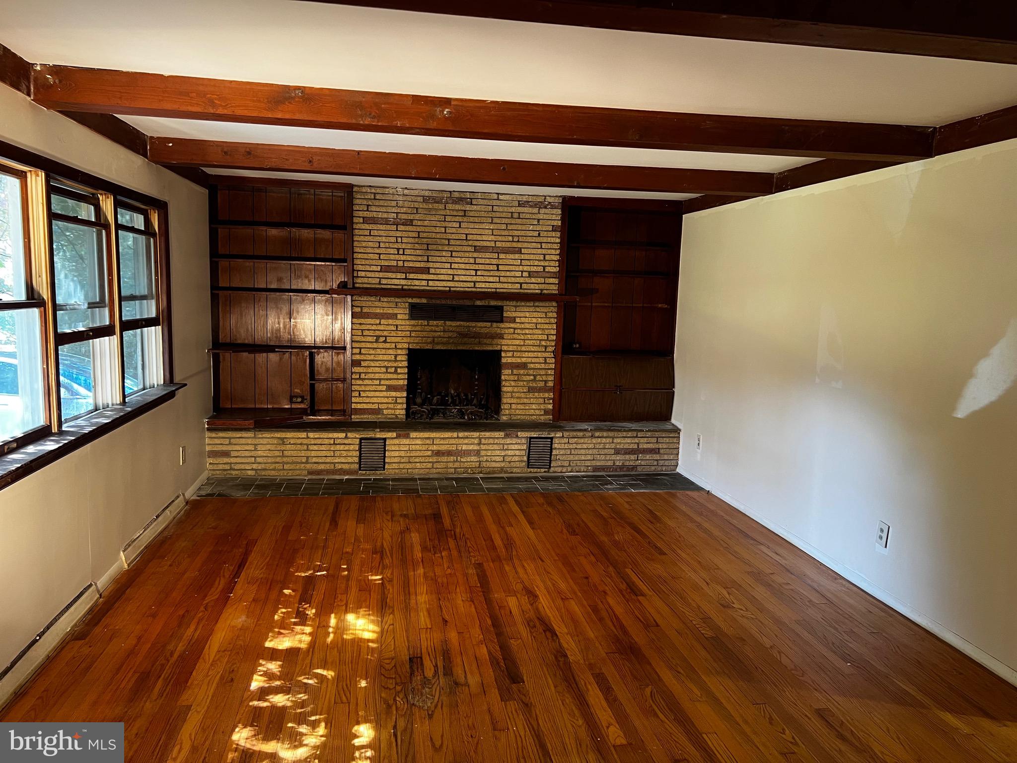 355 Wedgewood Road Newark, DE 19711 - Photo 7 of 20 a view of empty room with wooden floor and fireplace