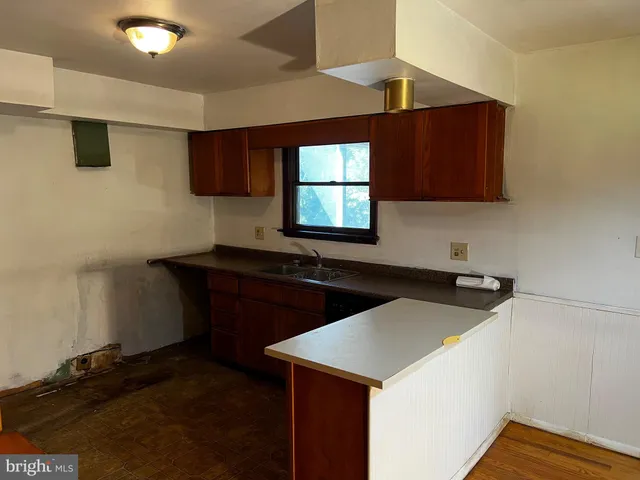 a kitchen with a sink a stove and a microwave