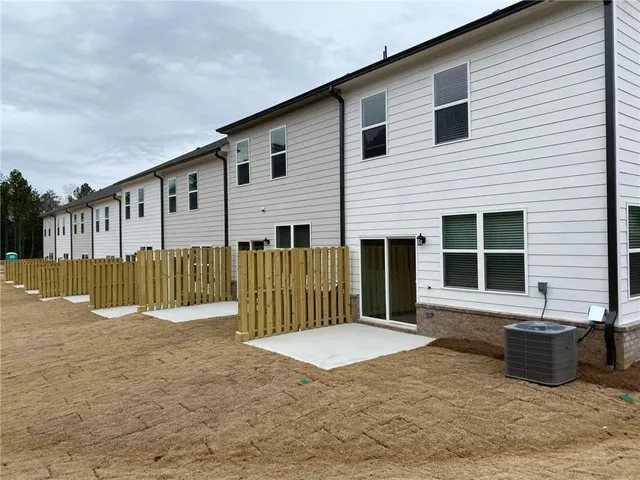 a view of a house with wooden fence
