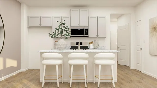 a kitchen with stainless steel appliances granite countertop a white cabinets and a stove top oven