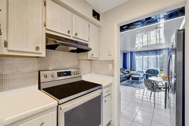 a kitchen with a stove and a refrigerator