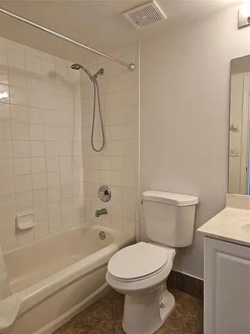 a bathroom with a toilet and shower