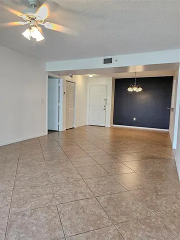 a view of an empty room with a ceiling fan