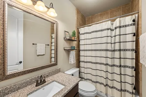 a bathroom with a sink toilet and shower