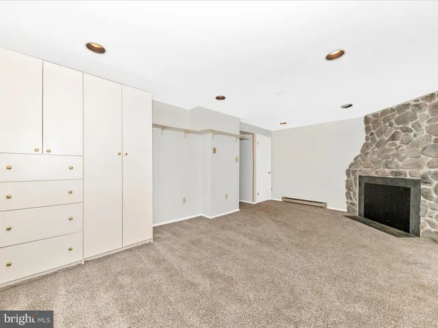 a view of an empty room with a fireplace