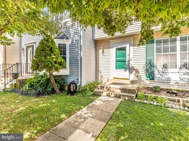 a view of a house with a yard and plants