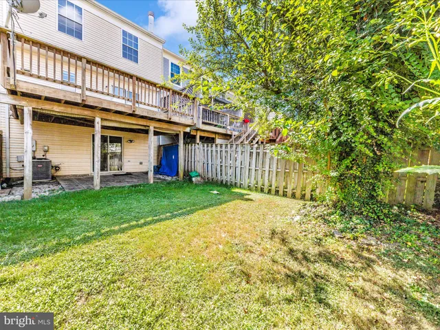 a view of yard with swimming pool and trees in the background