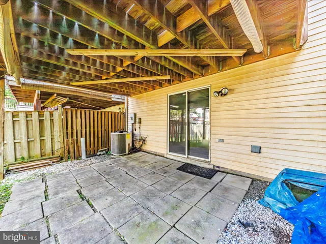 a view of a yard with plants and wooden fence