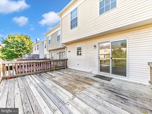 a view of a yard with plants and wooden fence