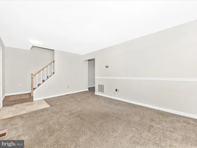 a view of an empty room with stairs