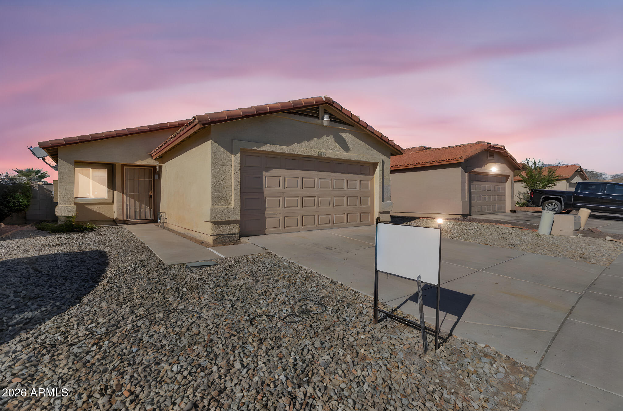 4545 North 67th Avenue, Unit 1211 Phoenix, AZ 85033 - Photo 1 of 16 a front view of a house with garden