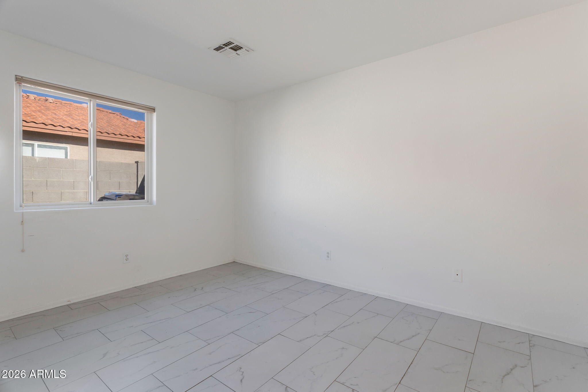 4545 North 67th Avenue, Unit 1211 Phoenix, AZ 85033 - Photo 13 of 16 an empty room with a window