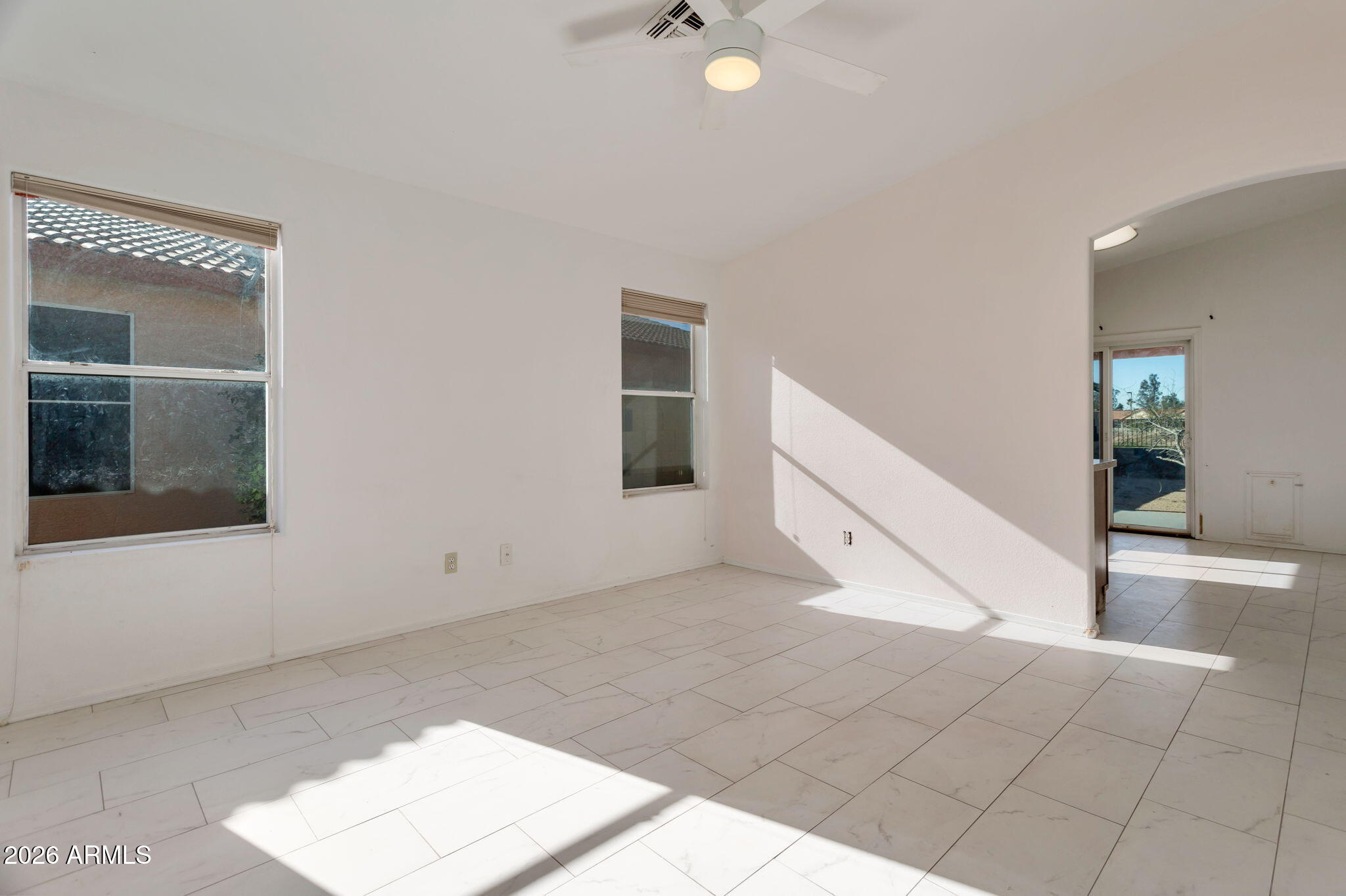 4545 North 67th Avenue, Unit 1211 Phoenix, AZ 85033 - Photo 5 of 16 a view of an empty room with kitchen and window