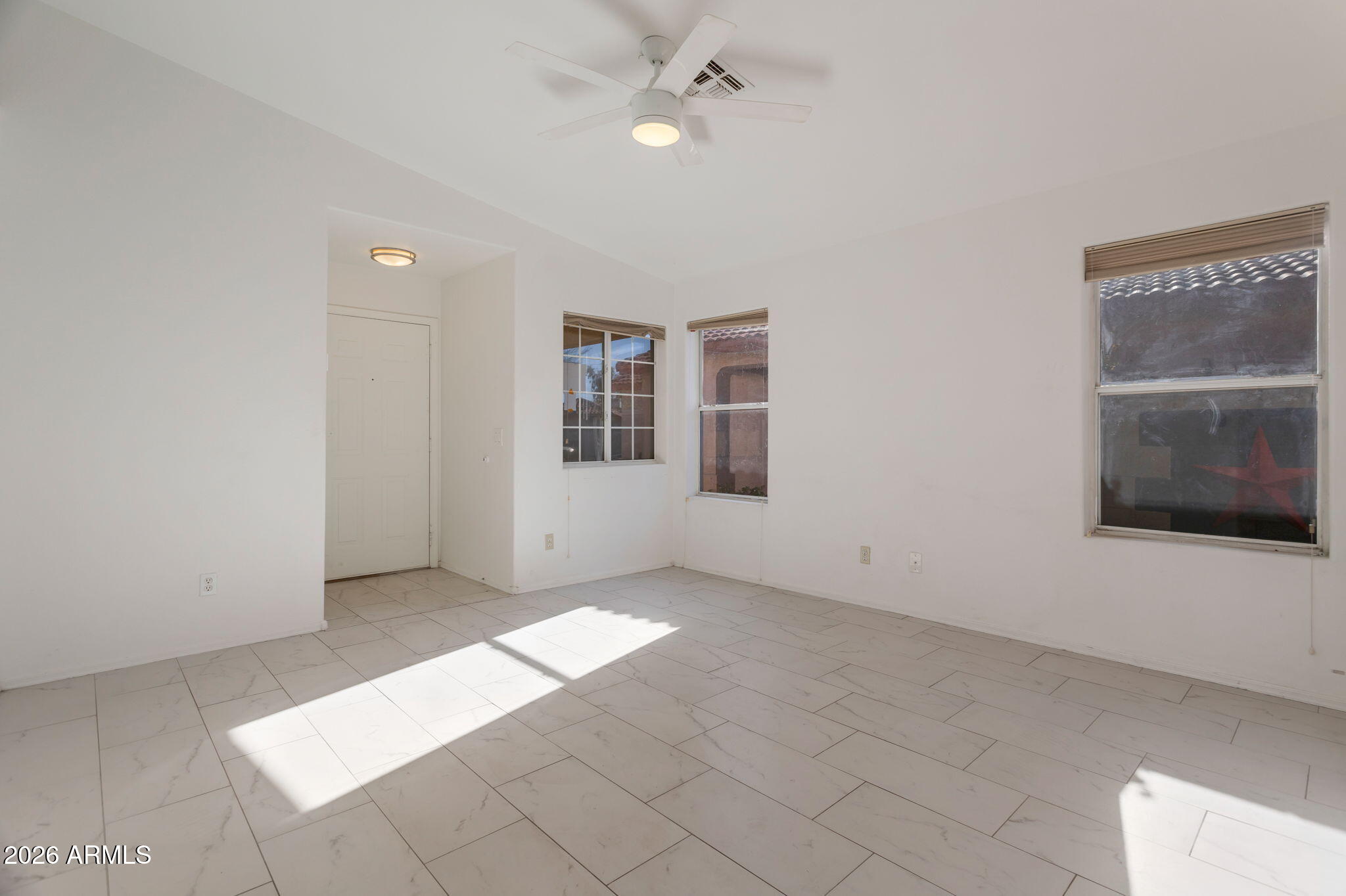 4545 North 67th Avenue, Unit 1211 Phoenix, AZ 85033 - Photo 6 of 16 an empty room with windows