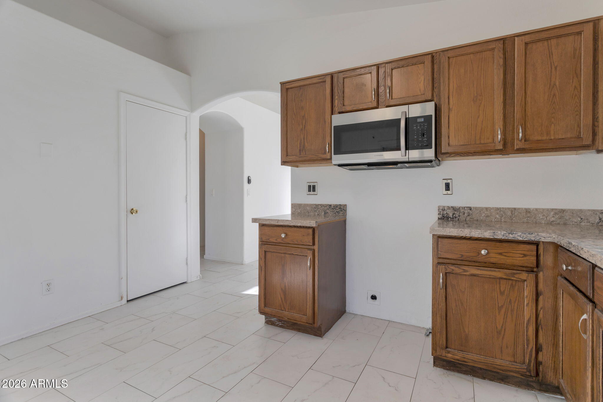 4545 North 67th Avenue, Unit 1211 Phoenix, AZ 85033 - Photo 8 of 16 a kitchen with stainless steel appliances granite countertop a refrigerator and a stove top oven