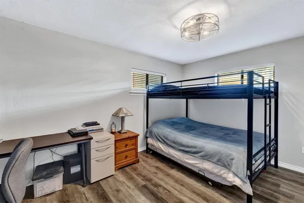 a bedroom with furniture and a window