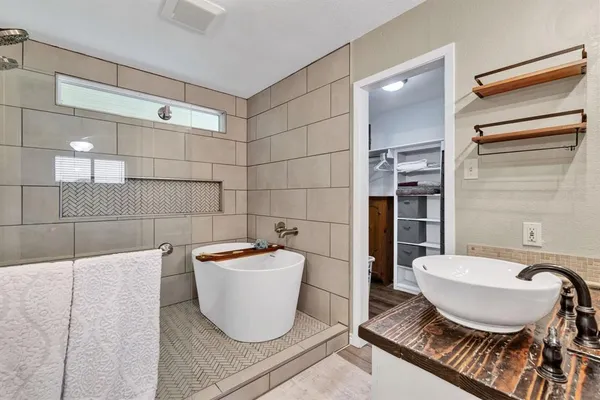 a bathroom with a bathtub and shower