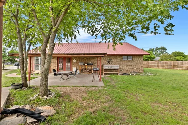 a front view of a house with garden and sitting area