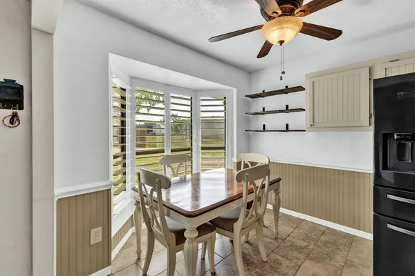 a view of a room with furniture and a ceiling fan