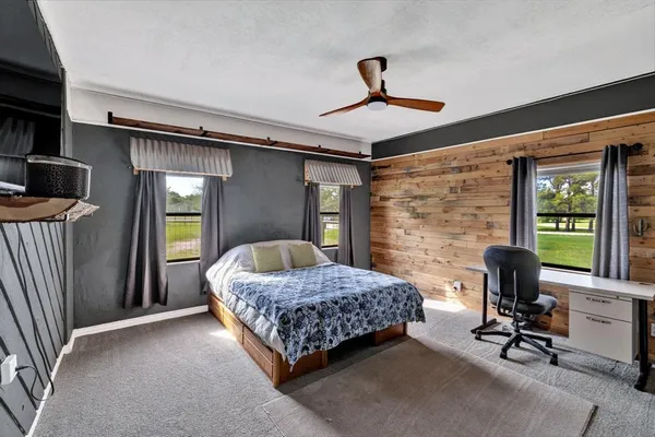 a bedroom with a bed chair and a window