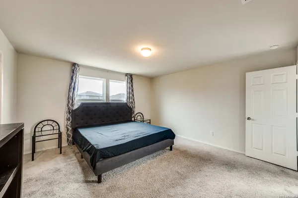 a bedroom with a bed and window