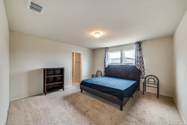 a bedroom with a bed and window