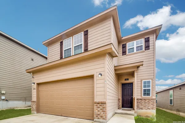 a front view of a house with garage