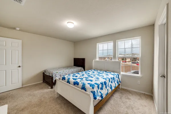 a bedroom with a bed and window