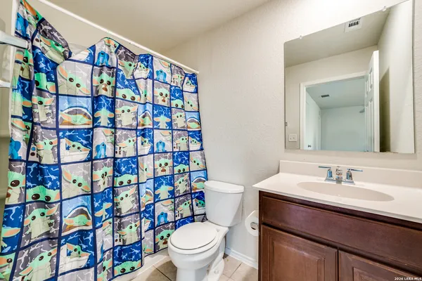 a bathroom with a sink toilet and a mirror