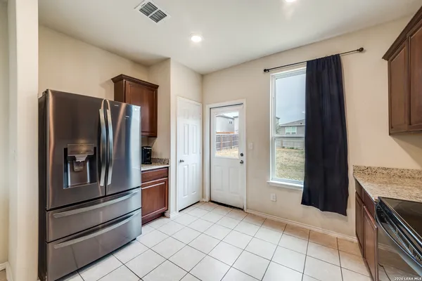 a kitchen with stainless steel appliances granite countertop a refrigerator and a sink
