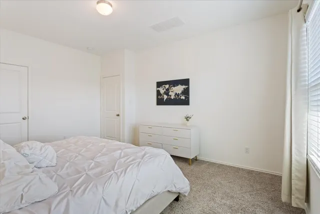 a bedroom with a bed and a cabinets