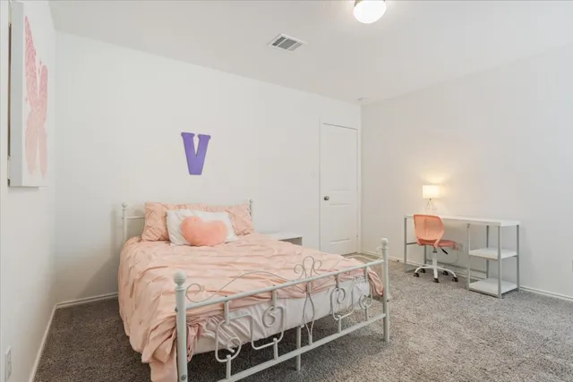 a bedroom with a bed and chair