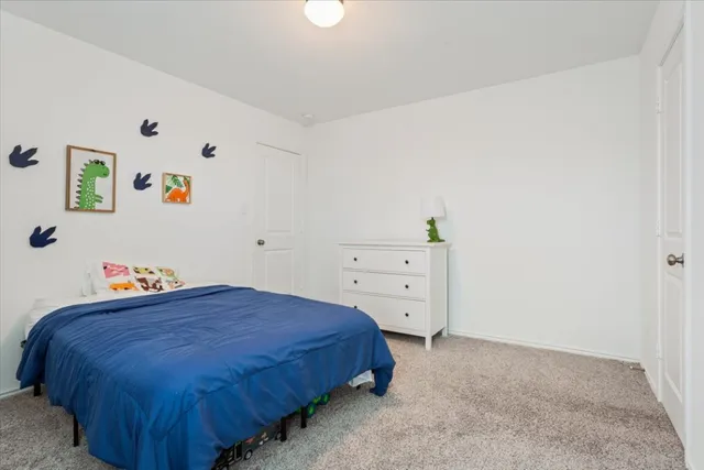 a bedroom with a bed and cabinet