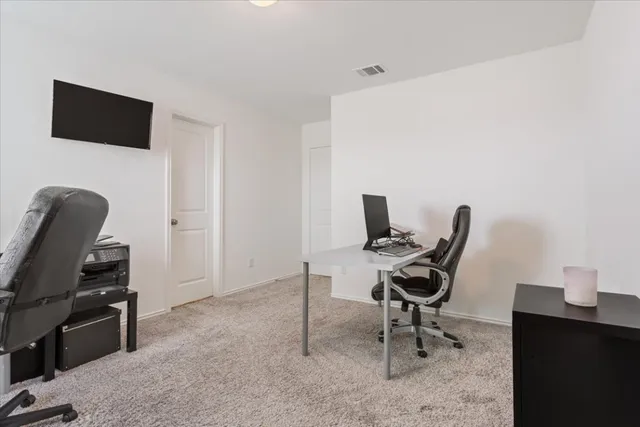 a view of a workspace with furniture