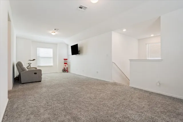 a bedroom with furniture and a flat screen tv