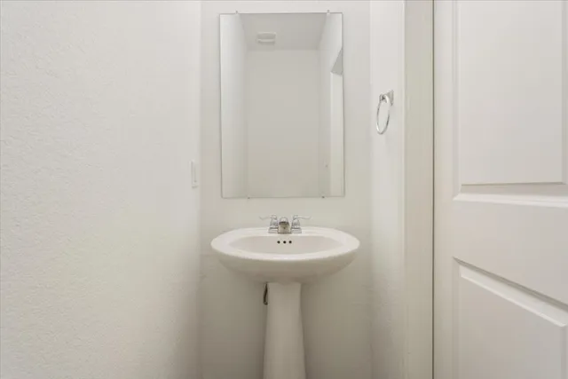 a bathroom with a sink a mirror and a shower