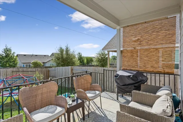 a balcony with table and chairs